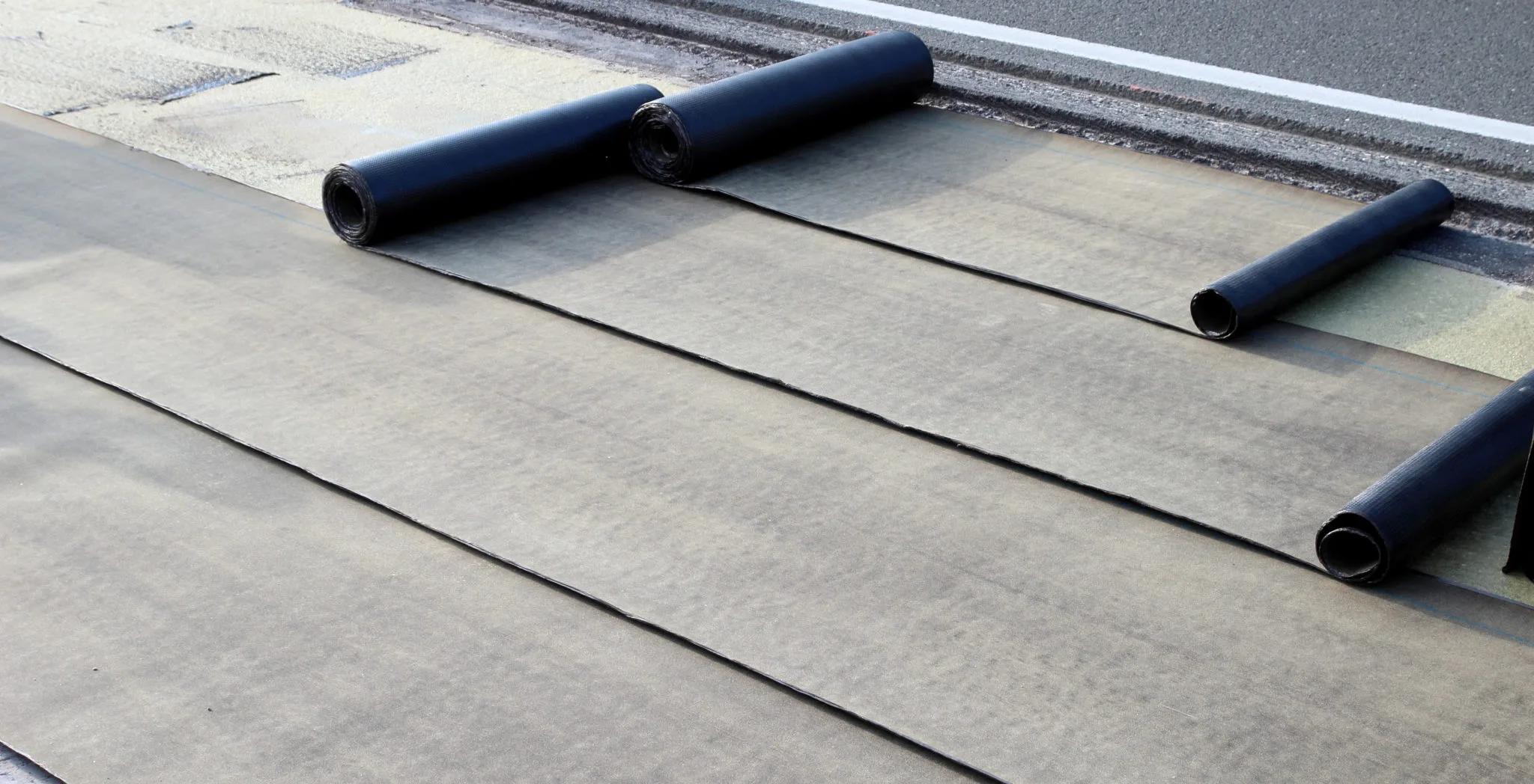 Commercial roof replacement materials staged on a flat roof