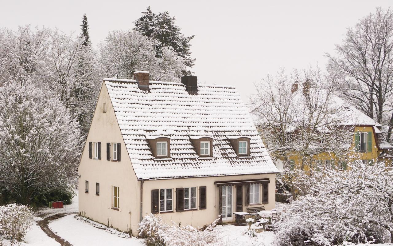 House with a snow-covered roof during an Alberta winter