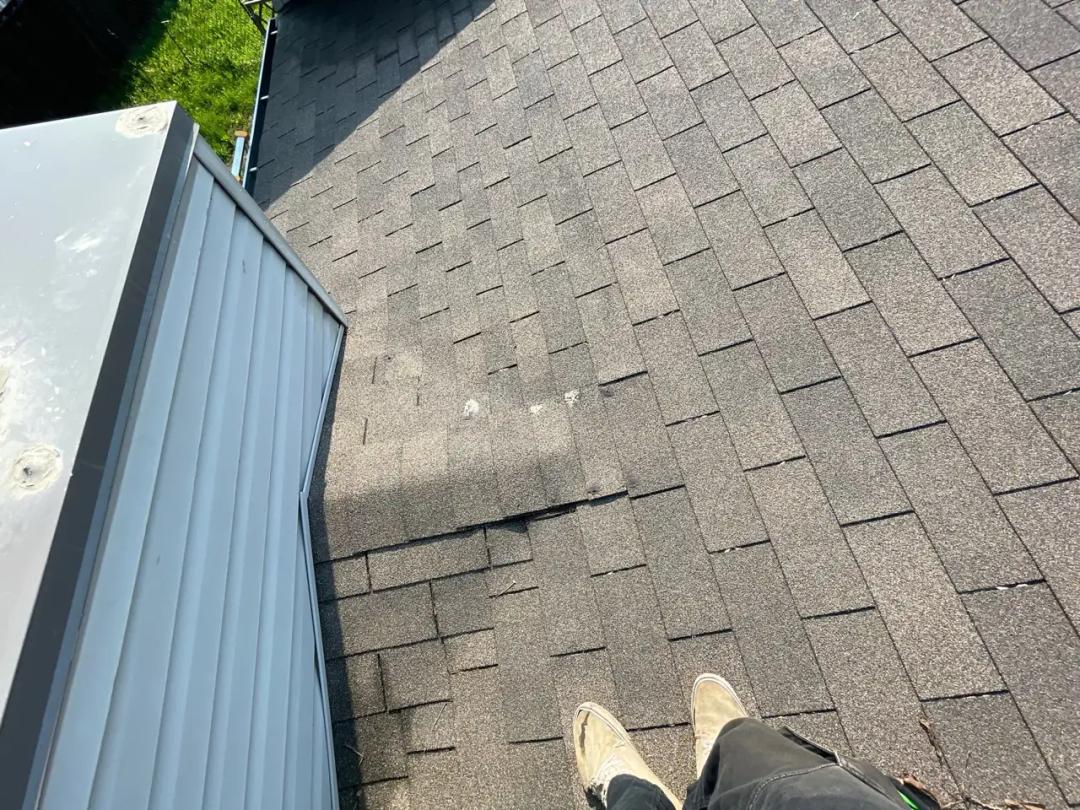 Completed shingle repair blended into the roof