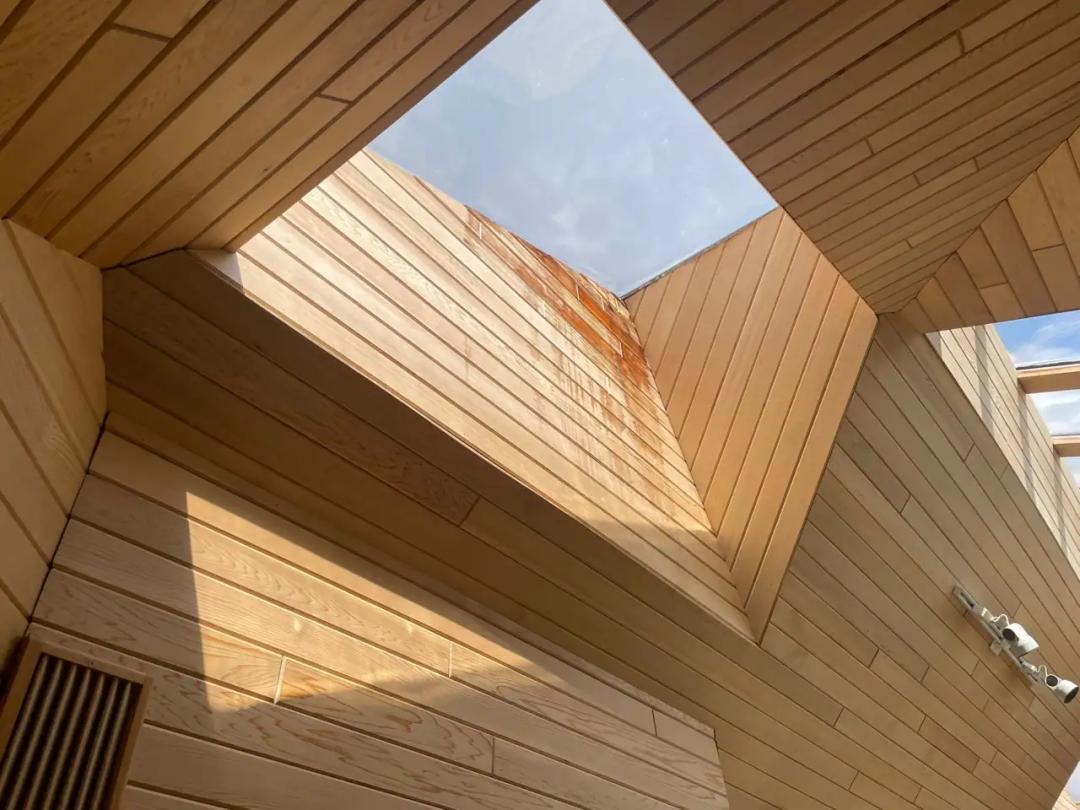 Skylight over a cedar-lined interior showing water staining