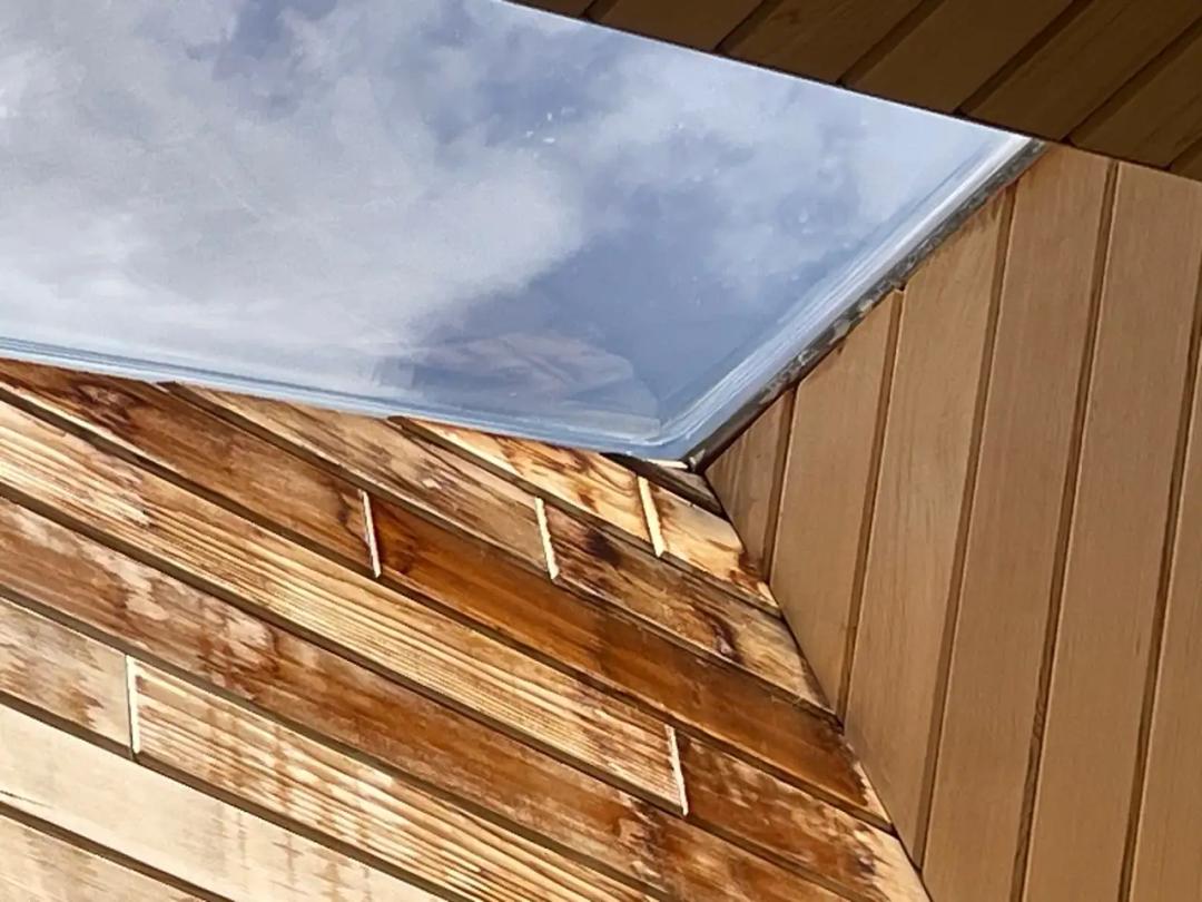 Inspecting the skylight from inside to trace the leak path
