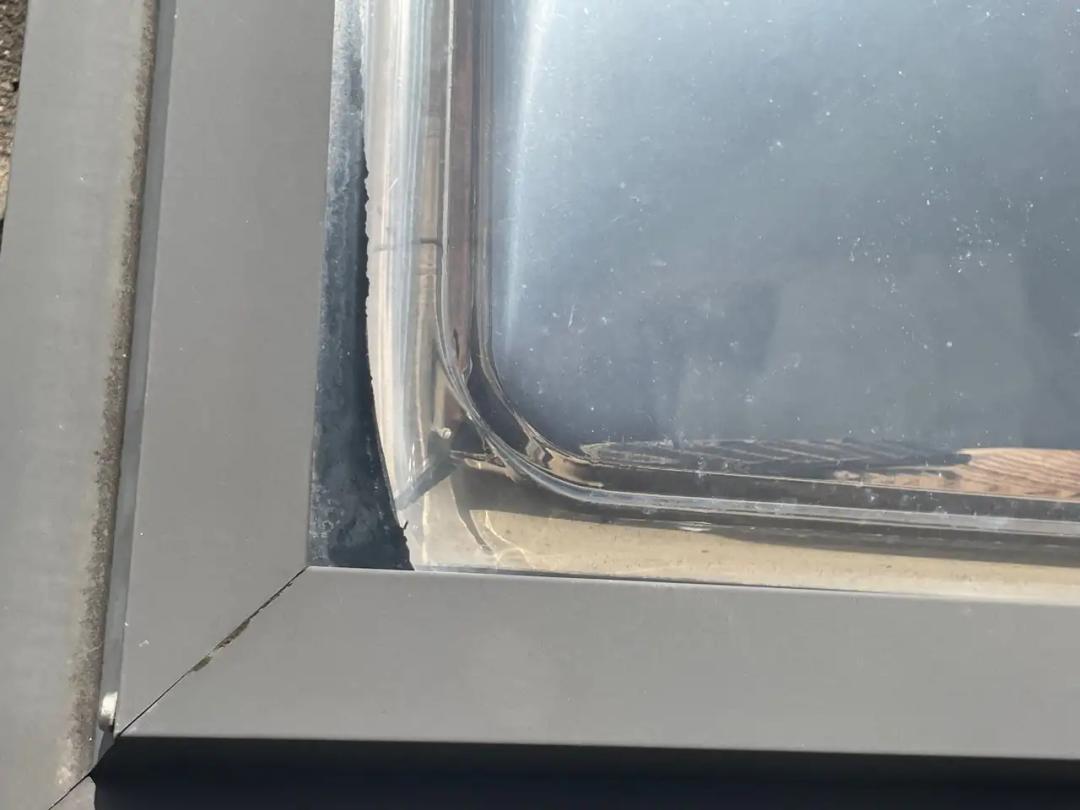 Fresh sealant applied around the skylight edge
